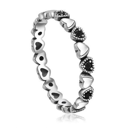 Side view of the silver heart jewelry with black gemstones, displaying the polished finish.