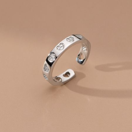 Detailed view of the intricate heart-shaped design and sparkling zircon stones on the silver ring.