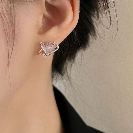 Detailed shot of the silver heart stud earring with a pink glittery center.
