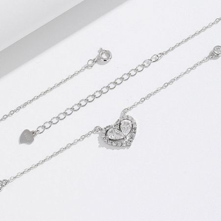 A pair of heart-themed silver necklaces from the collection.
