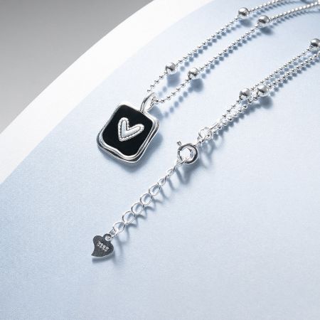 Detail of the adjustable bead chain clasp on the 925 sterling silver necklace.