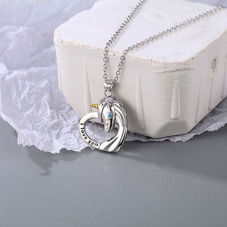 A silver necklace with a heart-shaped pendant engraved with 'I love you'.