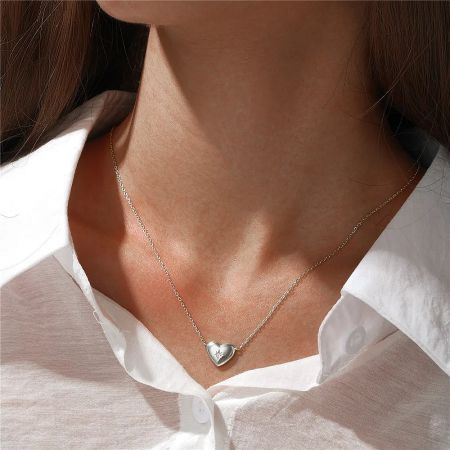 Model showcasing the silver version of the heart and star pendant necklace.
