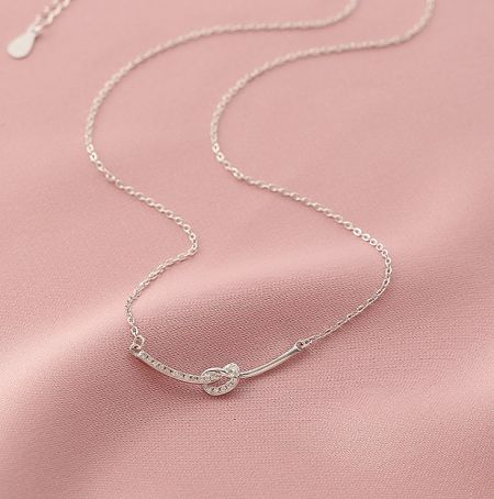 925 Sterling Silver Smile Necklace - A close-up of the 925 Sterling Silver Smile Necklace, showcasing its delicate heart-shaped pendant with a sparkling cubic zirconia stone.