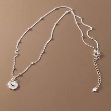 Side view of the sterling silver heart pendant necklace, showing the clasp and chain detail.