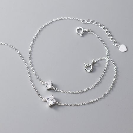 Two sterling silver single zircon bracelets shown side-by-side to compare the different stone sizes.