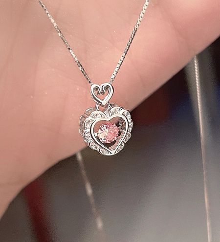 925 Sterling Silver Dancing CZ Open Heart Necklace - Close-up of a 925 sterling silver open heart necklace featuring a central dancing pink cubic zirconia gemstone.