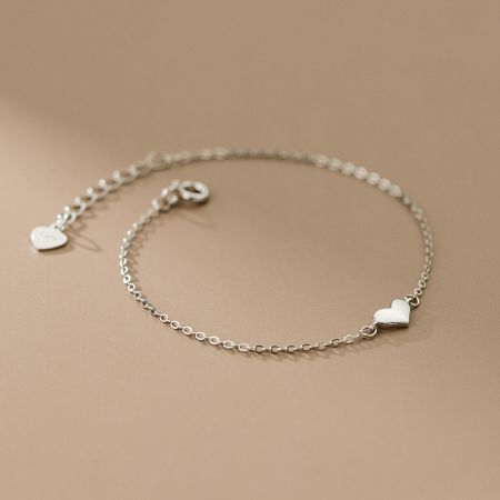 A detailed view of the sterling silver heart chain bracelet, highlighting its delicate charm.