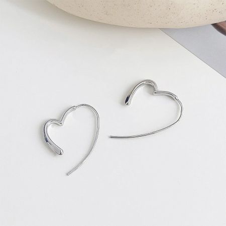 An alternative view of the silver heart-shaped hoop earrings, highlighting their sleek design.