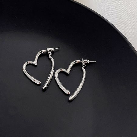 Clean product shot of the silver heart-shaped earrings, highlighting their polished finish.
