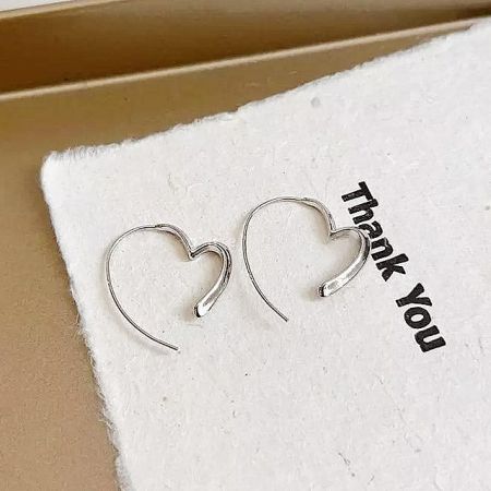 The silver heart hoop earrings presented in a stylish 'Thank You' branded box, perfect for gifting.