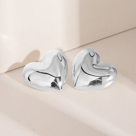 A pair of silver heart-shaped stud earrings.