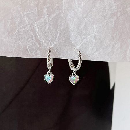 A pair of silver heart opal earrings with a twisted rope design detail.