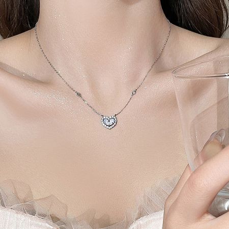 Detailed view of the sparkling cubic zirconia on the silver heart pendant.