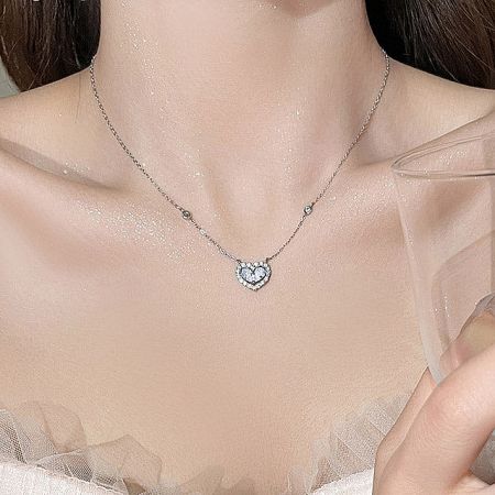Elegant silver heart-shaped pendant on a delicate chain.