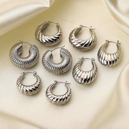 A collection of silver hoop earrings with various twisted and ribbed designs.