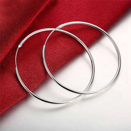 925 Sterling Silver 50mm Circle Big Hoop Earrings (5 pairs) - A pair of classic 50mm 925 sterling silver hoop earrings displayed on a rich red fabric background.
