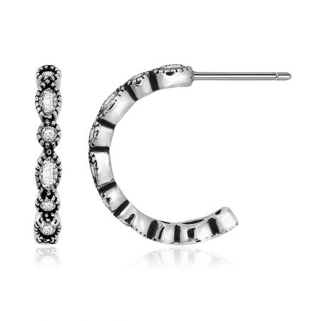 Detailed view of the small zirconia half hoop earring showcasing the clear gemstones.