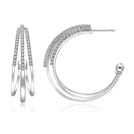 Detailed view of the triple rows of cubic zirconia on the semi-hoop earrings.