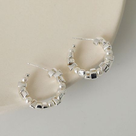 Side profile of the C hoop earring with pearls and cubic beads, highlighting its elegant curve.