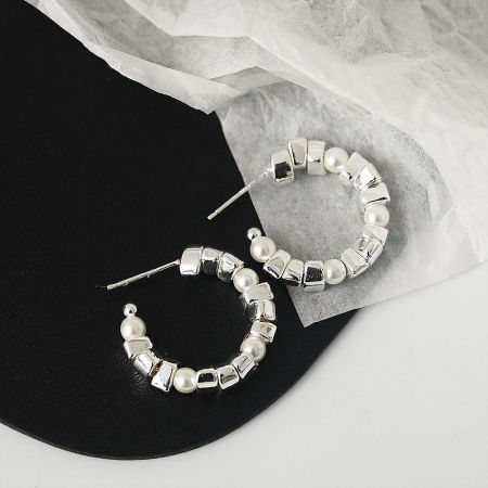 Close-up shot of the post-style earring back on the silver hoop earring.