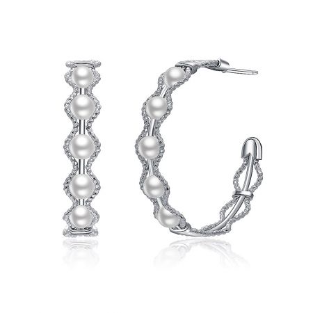 Close-up detail of the silver hoop earrings with white pearls, highlighting the intricate twisted rope-like design with diamond accents.