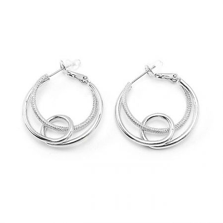 Angled shot of the polished double circle hoop earrings, showing the contrast between the textured and smooth surfaces.