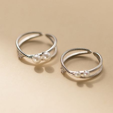 Close-up view of a sterling silver ring from the set, featuring an intricate design with zirconia stones.