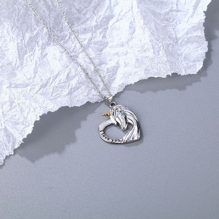 A silver necklace with a unique horse-head heart pendant.