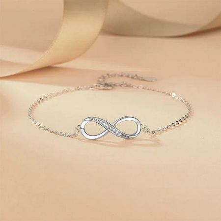 Elegant sterling silver infinity bracelet adorned with cubic zirconia.