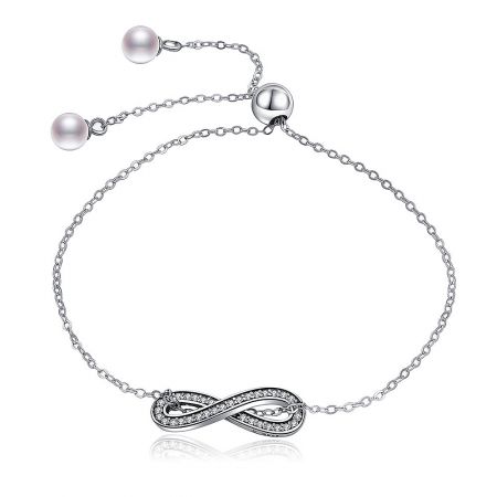 Infinity Pave Bracelet in Sterling Silver - Elegant sterling silver infinity pave bracelet featuring a sparkling cubic zirconia centerpiece and a delicate pearl on the adjustable clasp.