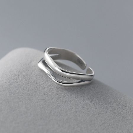 Another angle showcasing the elegant intertwined contours of the silver wave ring.