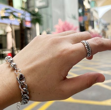 Model wearing the stainless steel wheat ring, showcasing its adjustable fit and style.