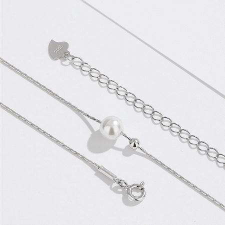 The sterling silver pearl necklace paired with a matching bracelet to create a complete jewelry set.