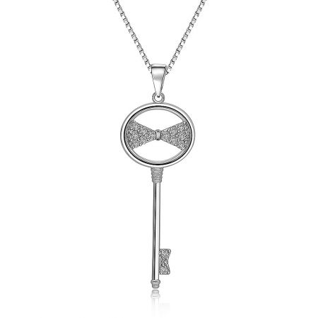 Detailed close-up of the key pendant's bow and cubic zirconia stones.