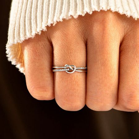 Model wearing the Eternal Bond silver knot ring on the middle finger.
