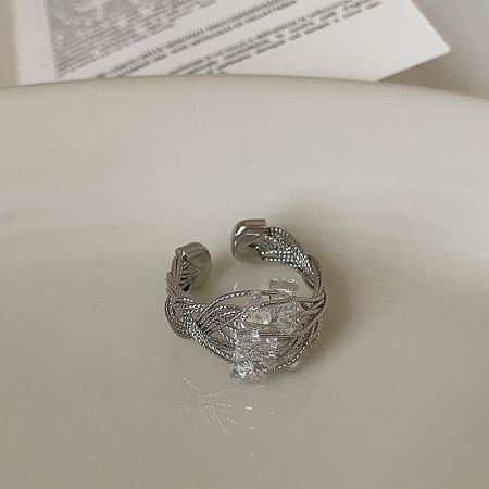 Close-up view of an adjustable wire-wrapped ring with a cluster of clear crystals, highlighting its detailed craftsmanship.