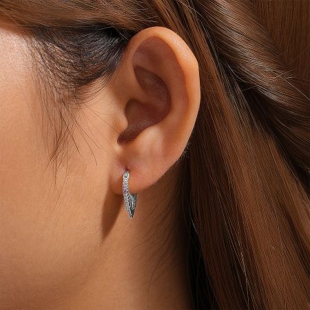 The sterling silver variant of the leaf-design hoop earrings, adorned with brilliant zircon stones.
