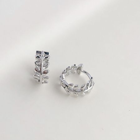 Top-down view of the pair of silver leaf wreath hoop earrings.