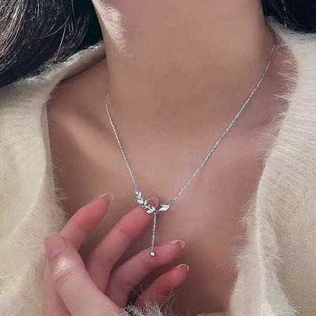 Close-up of a 925 sterling silver necklace with a delicate leaf-shaped pendant.