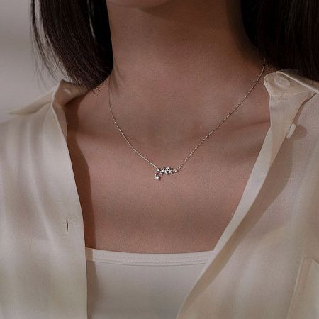 Close-up of the silver version of the delicate leaf pendant necklace.