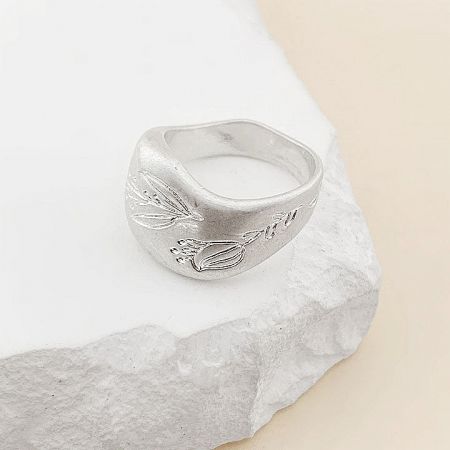 Another angle of the silver leaf-patterned chunky band ring.