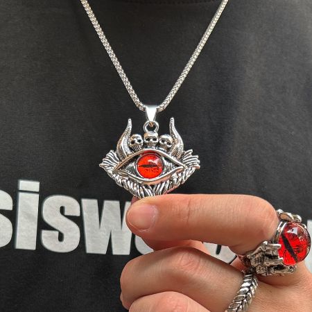 The red evil eye pendant necklace shown alongside a matching skull ring.