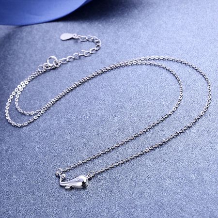 Side profile of the silver animal-themed pendant necklace.