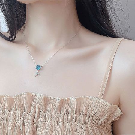 Model wearing the elegant S925 silver fish-tail necklace to show scale and style.