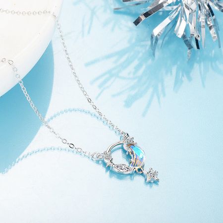 Close-up of a silver necklace with a unique blue gemstone pendant.