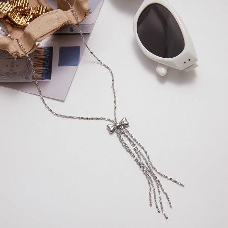 Wholesale Stainless Steel Necklace Set of 5 with Bow Tassel Pendant - A detailed studio shot of the wholesale stainless steel necklace, highlighting the delicate bow pendant and elegant tassel design.