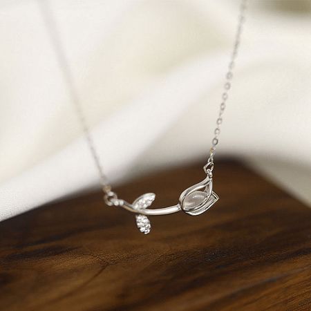 Stylish silver necklace showcasing a unique pendant with clear stones, included in the set.