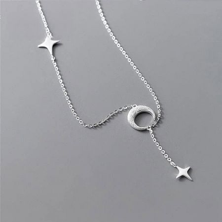 Close-up view of the celestial-themed pendants on the silver necklace.