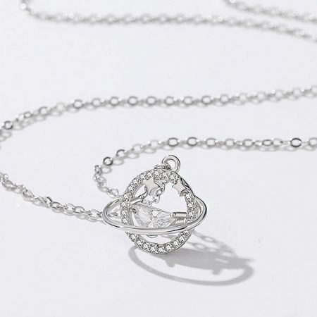 Close-up of a sterling silver necklace with a brilliant crystal pendant, part of the celestial collection.